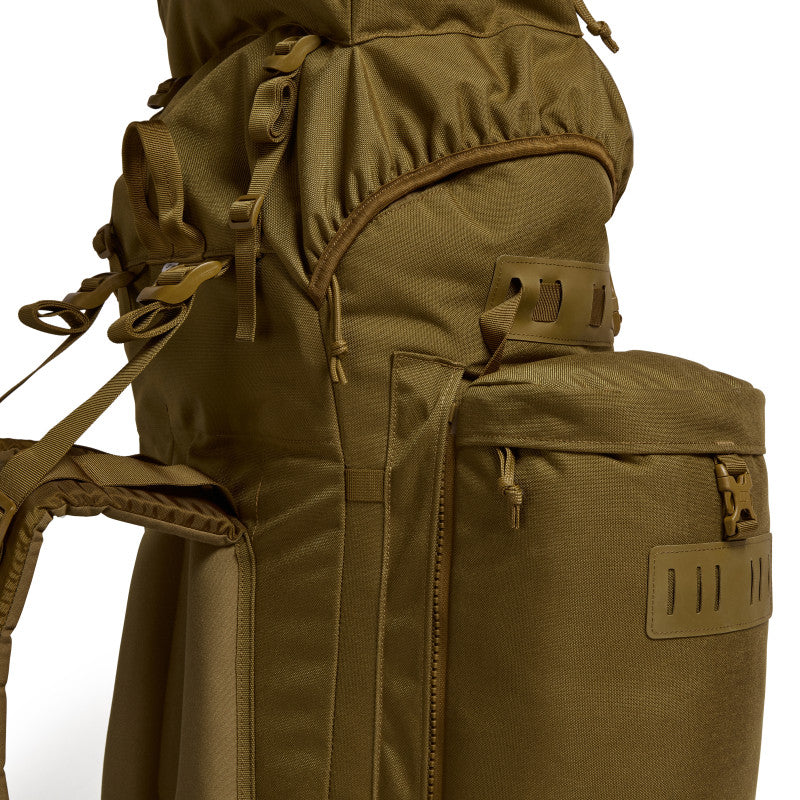 Close-up side detail of the Berghaus Vulcan V MMPS rucksack showing zip access, fabric texture, and side pocket attachment points.