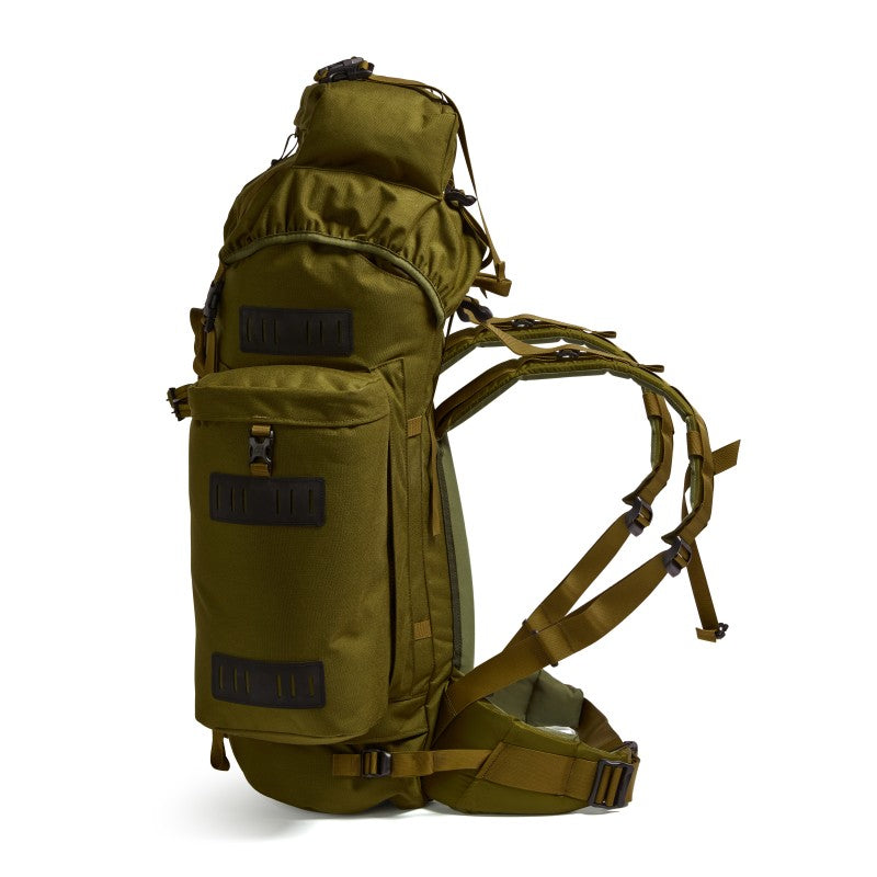 Side profile of the Berghaus Vulcan V MMPS cedar military rucksack displaying large side pocket, compression straps, and padded hip belt.