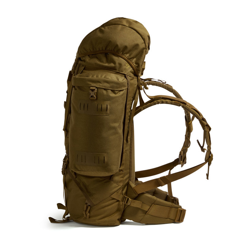 Side profile of the Crusader 90 + 20 FA military backpack in earth brown showing compression straps and padded harness system.