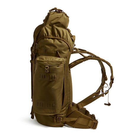 Side profile of the Berghaus Vulcan V MMPS rucksack in earth brown showing side pocket, compression straps, and adjustable harness.