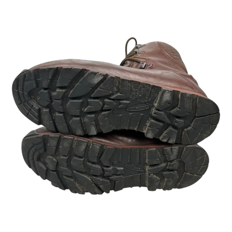 Sole view of brown leather Iturri patrol combat boots, two boots stacked showing black lug tread pattern, military surplus, transparent cutout