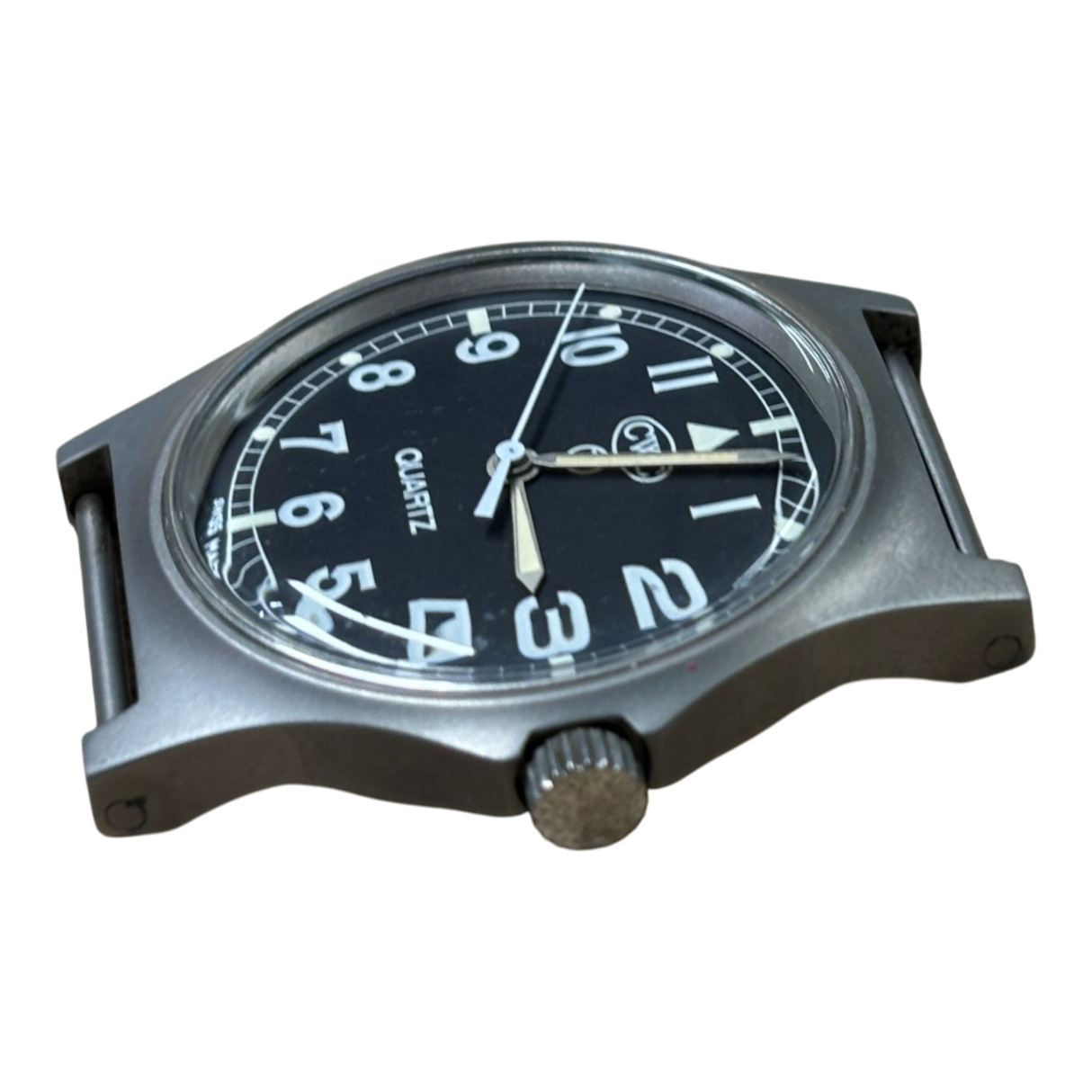 Low angle view of CWC G10 military watch showing case profile, acrylic crystal and unsigned crown