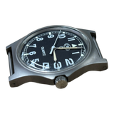 Low angle view of CWC G10 military watch showing case profile, acrylic crystal and unsigned crown
