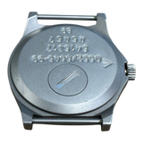 Case back of CWC G10 watch with battery hatch, engraved Broad Arrow, Royal Navy issue markings 0552/6645-99, serial number and 89 date stamp