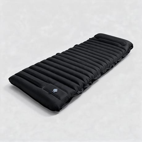 Black self-inflating sleeping mat with built-in pump, fully inflated