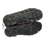 Underside of British Army Wellco combat boots displaying deep-lug rubber tread pattern with light signs of previous use, providing excellent grip for outdoor and tactical environments.